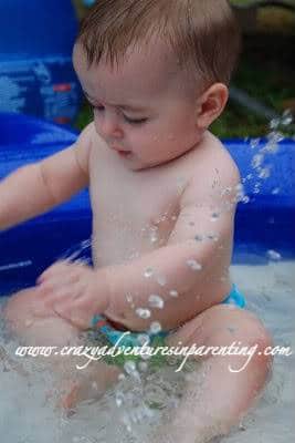 baby splashing in pool