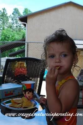 toddler eating chips on dora plate