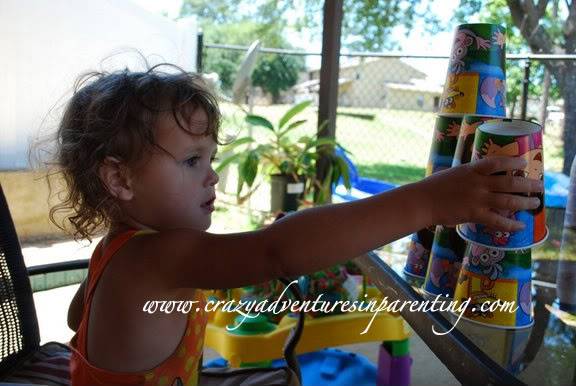 toddler building with cups