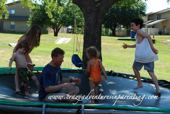 dad and kids on trampoline