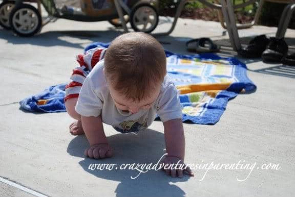 infant crawling shadows at pool
