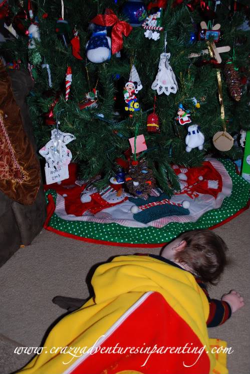 sleepy kid under the Christmas tree