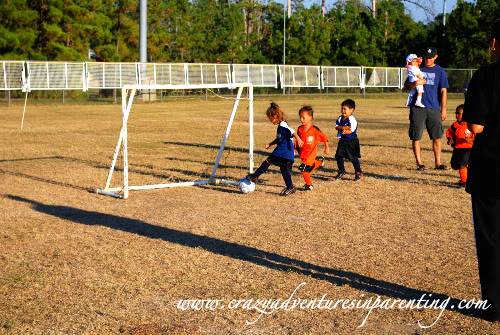 toddler scoring a goal