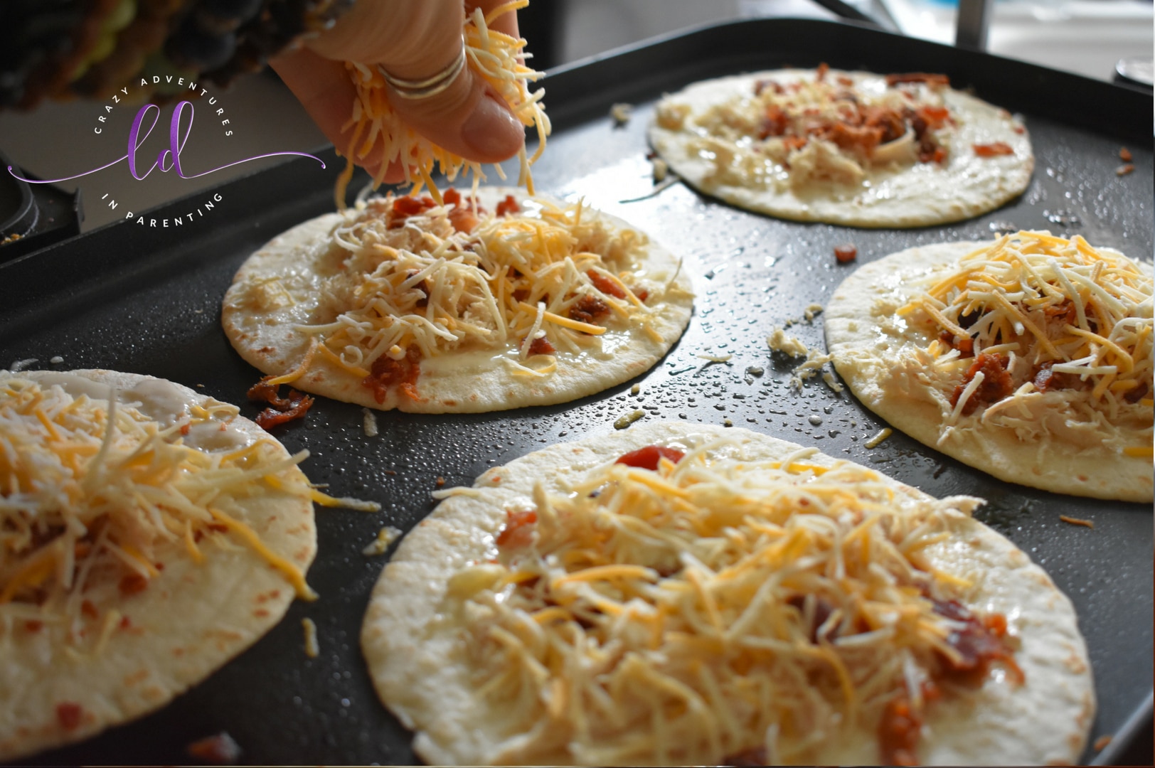 Sprinkle Shredded Cheese on Chicken Bacon Ranch Quesadillas