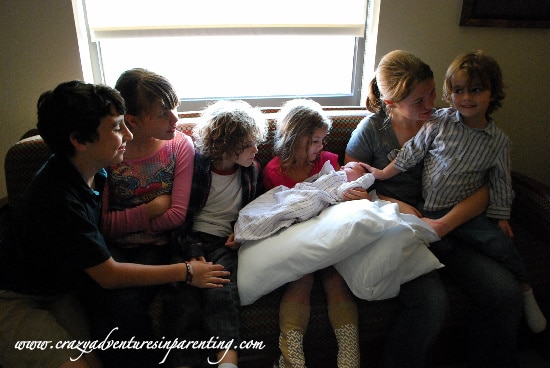 Meeting their baby sister for the first time.