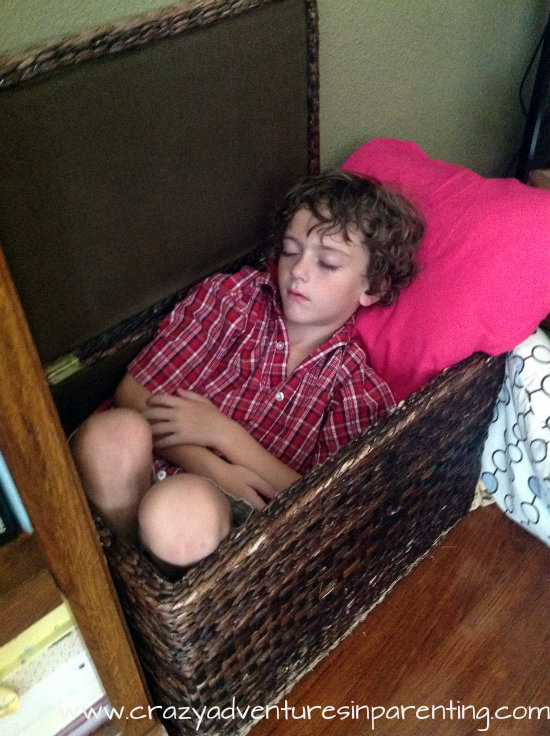 Kids sleep anywhere, even in the blanket basket.