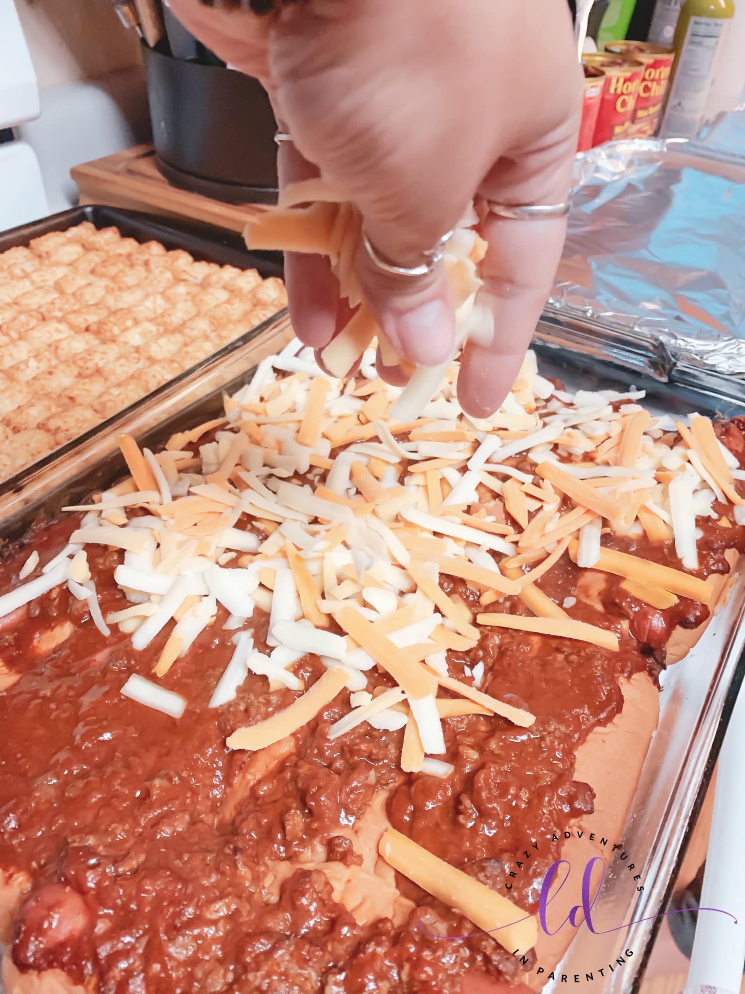 Add Cheese to Easy Baked Chili Cheese Hot Dogs