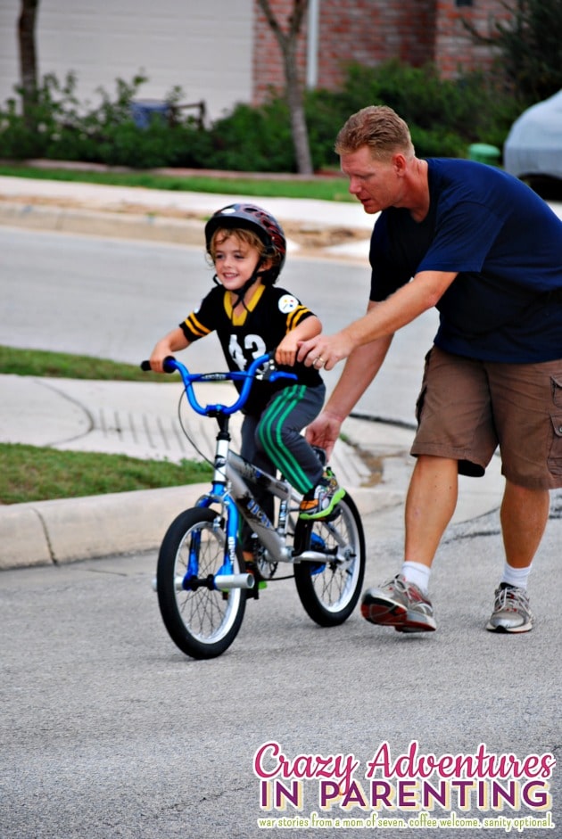 baby dude riding a two wheeler