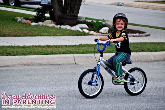 baby dude riding a two wheeler