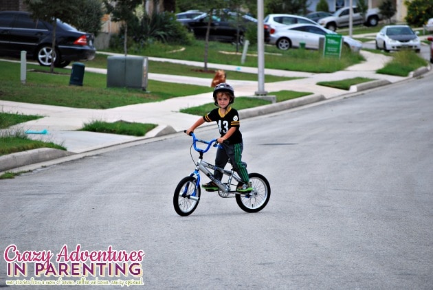 baby dude riding a two wheeler
