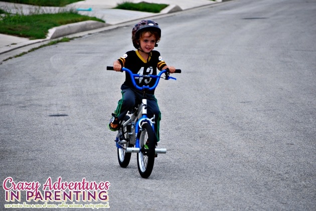 baby dude riding a two wheeler