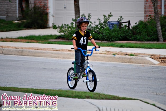 baby dude riding a two wheeler