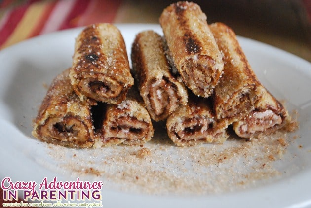 nutella peanut butter cream cheese roll ups with cinnamon sugar in half