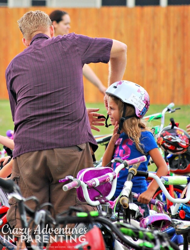 dad helping her with her helmet