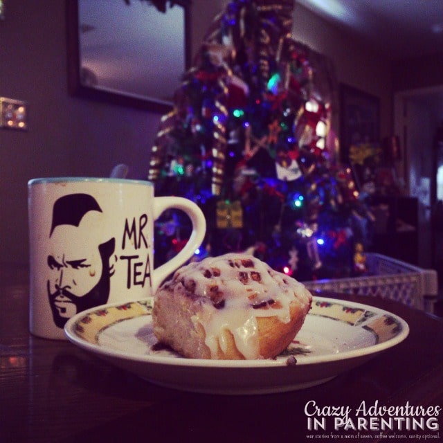 cinnamon bun and coffee by the christmas tree