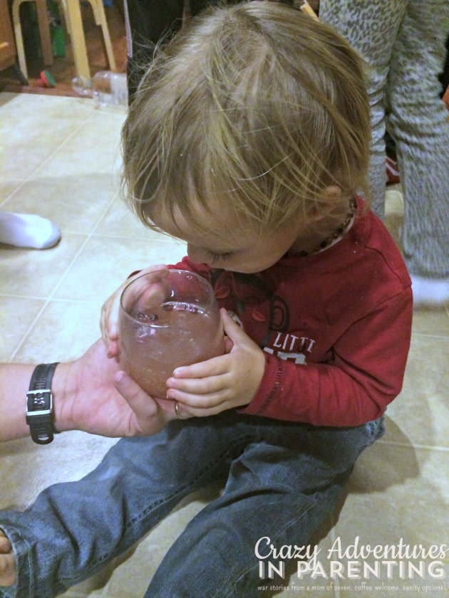 baby holding sparkling juice