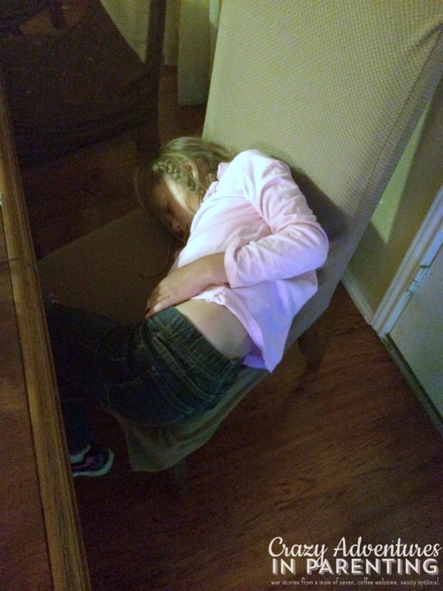 first grader asleep on dining chair