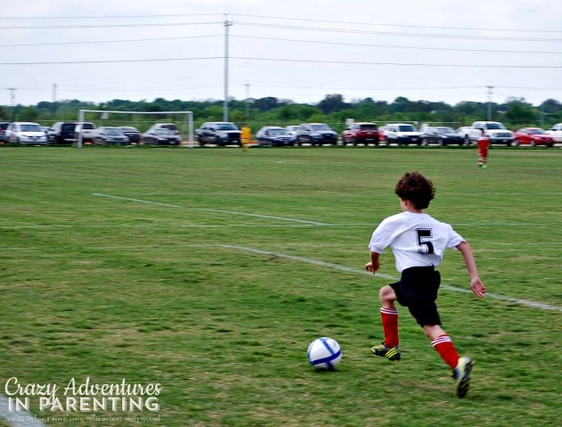 soccer taking it up the field all alone