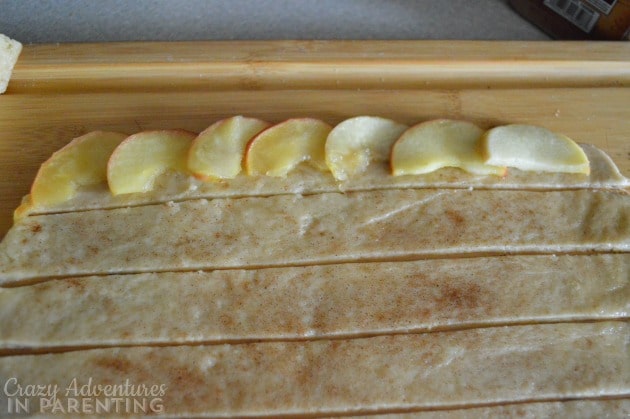 layer sliced apples on the dough