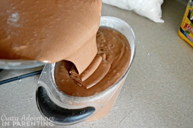 Pouring fudge into measuring cup