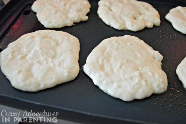 Cinnamon Roll Pancake Bake pancakes on the griddle