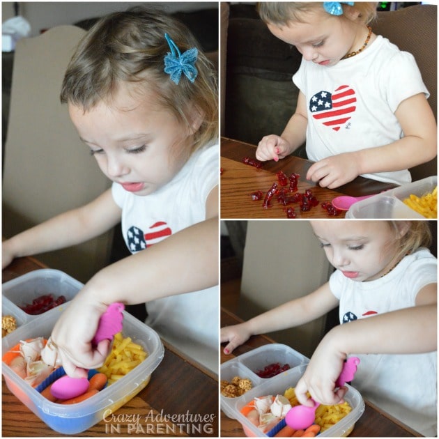 Toddler eating her school lunch