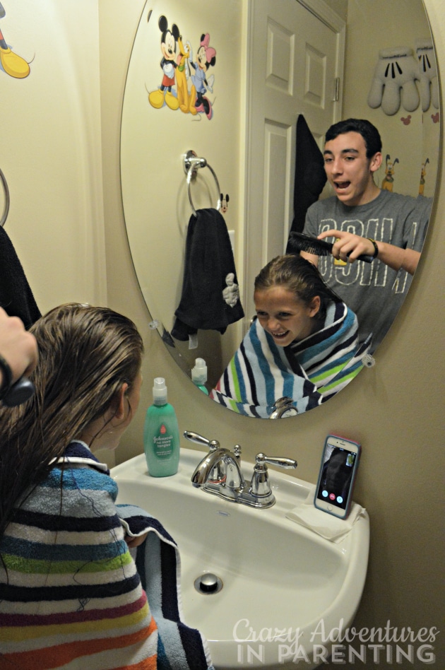 big brother bonding with sister while brushing hair