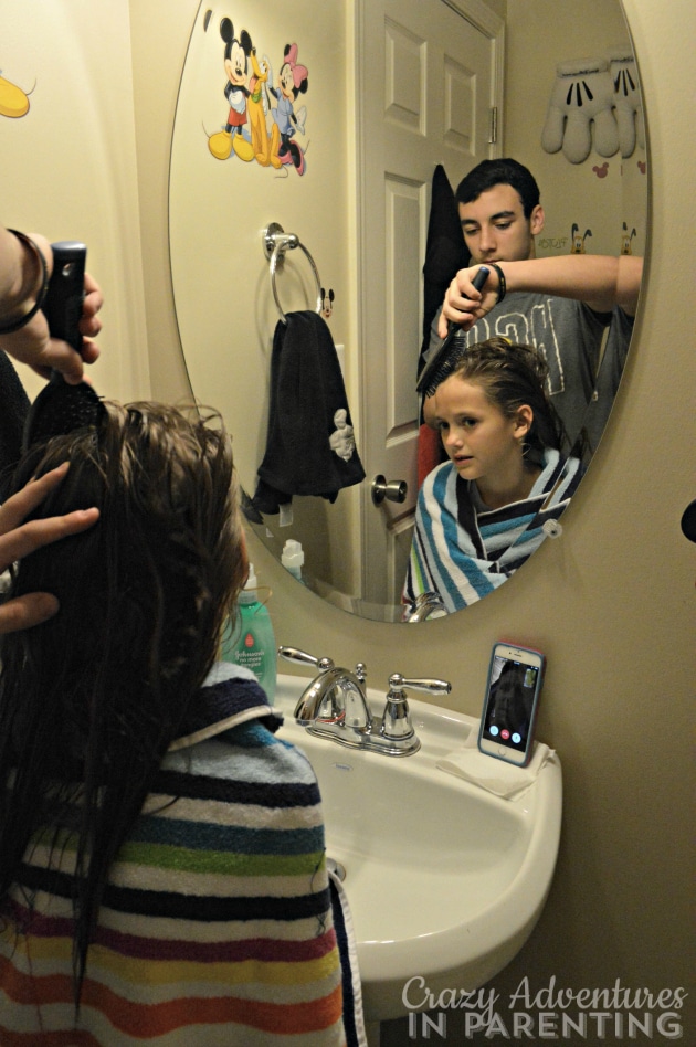 big brother brushing sister's hair