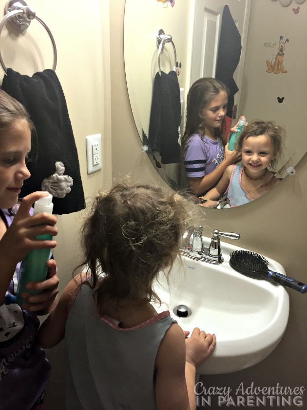 big sister doing little sisters hair
