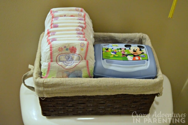 Pull-Ups and wipes in a basket on the back of the toilet