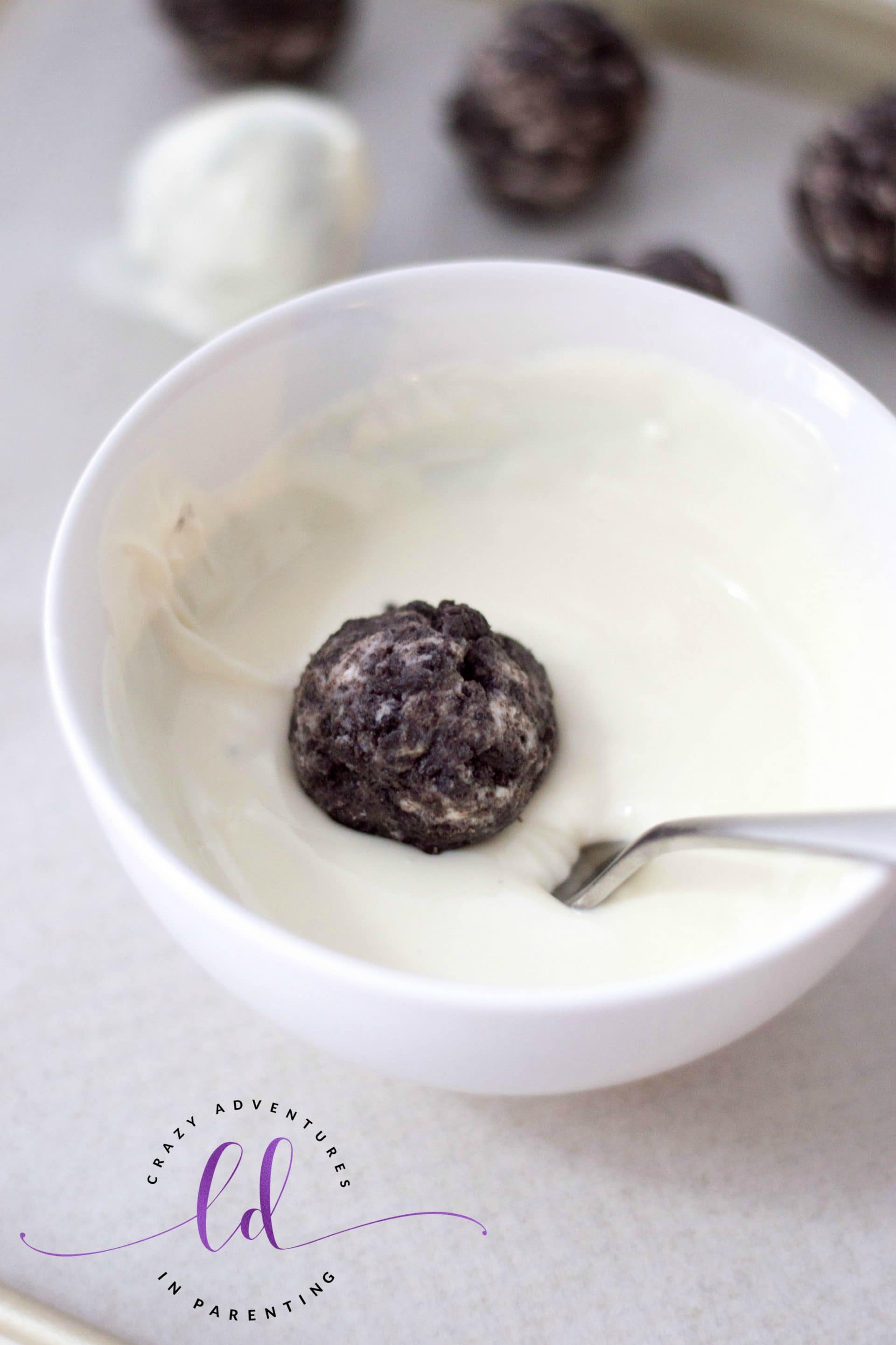 Dip Cookie Balls into White Chocolate for Peppermint Oreo Truffles