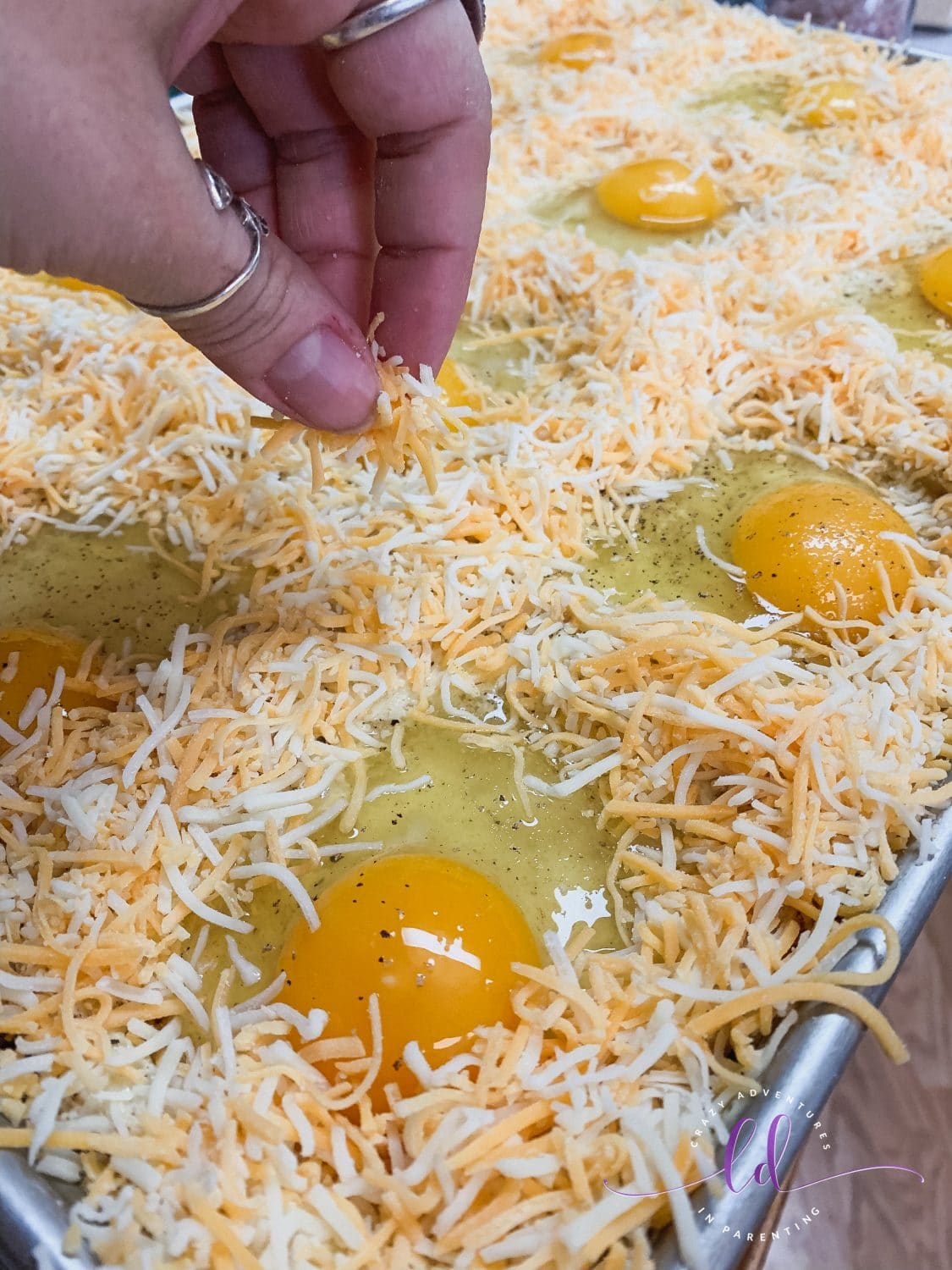Adding Cheese to Sheet Pan Cheesy Baked Egg Toast