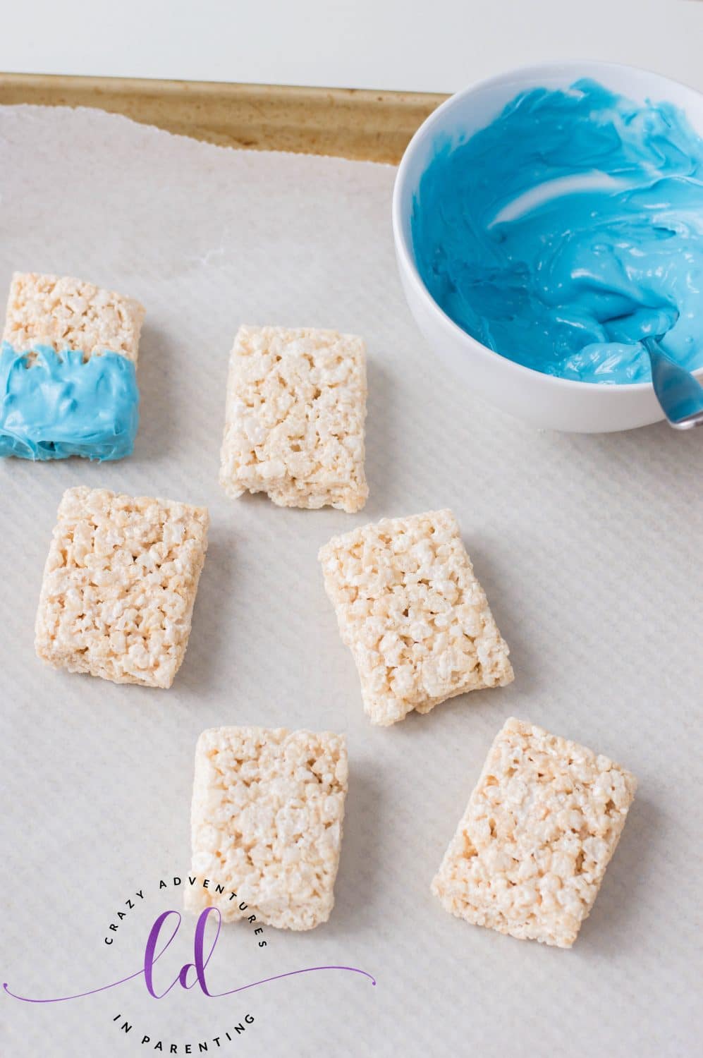 Dipping Mermaid Rice Krispies Treats in Candy