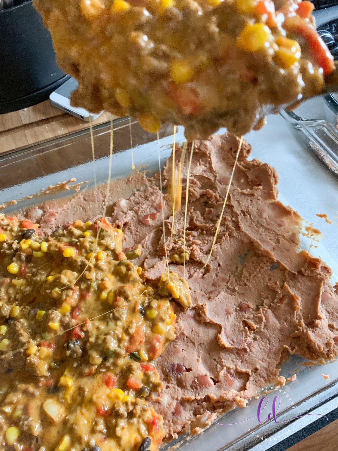 Layer over Refried Beans for Best Taco Casserole Recipe