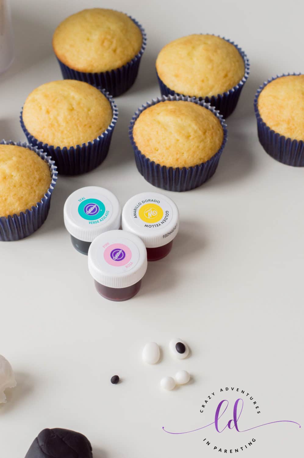 Add black fondant to make eyeballs for Tie-Dye Poop Emoji Cupcakes