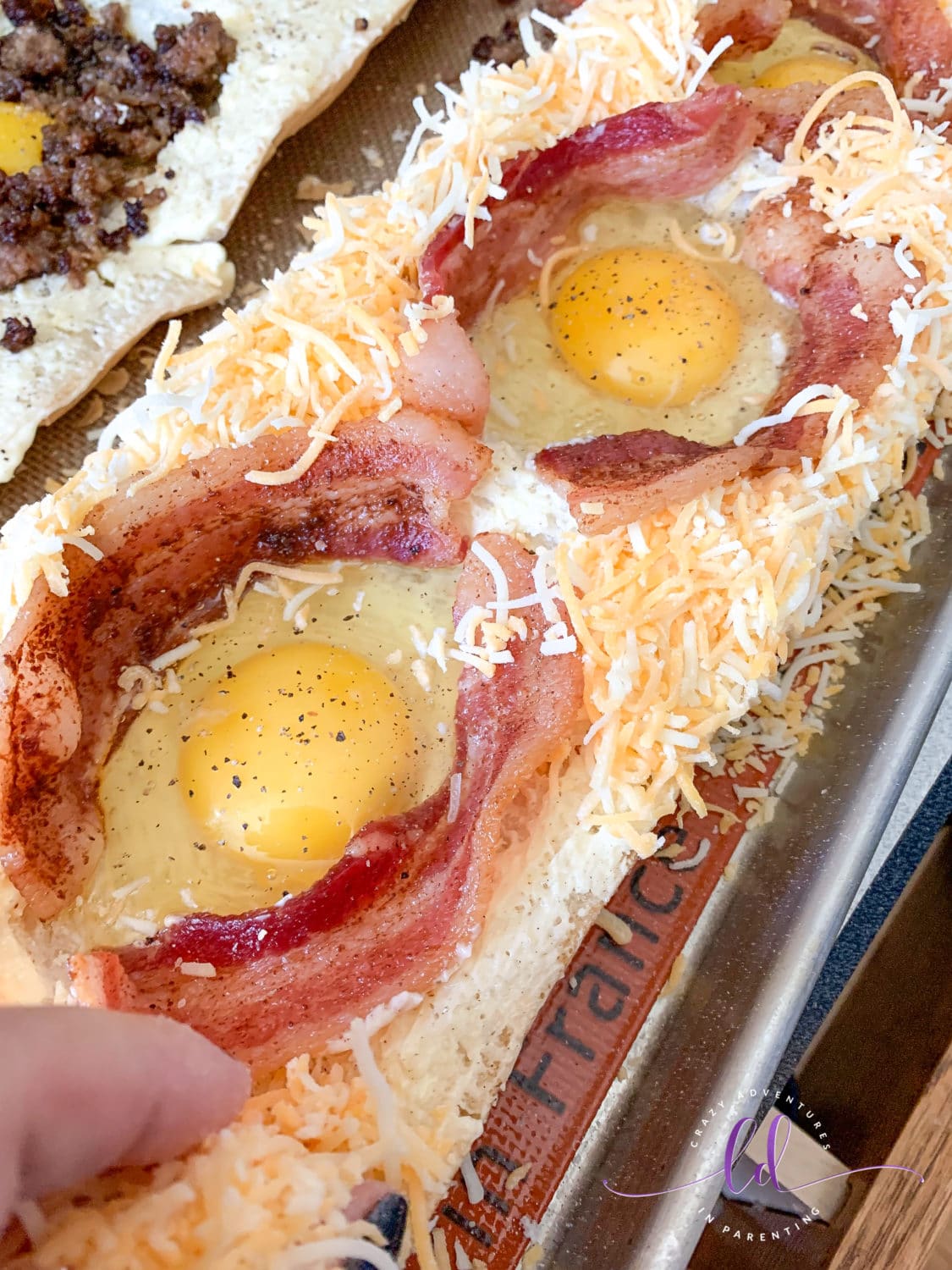 Add cheese to the Bacon Cheesy Baked Egg Italian Toast