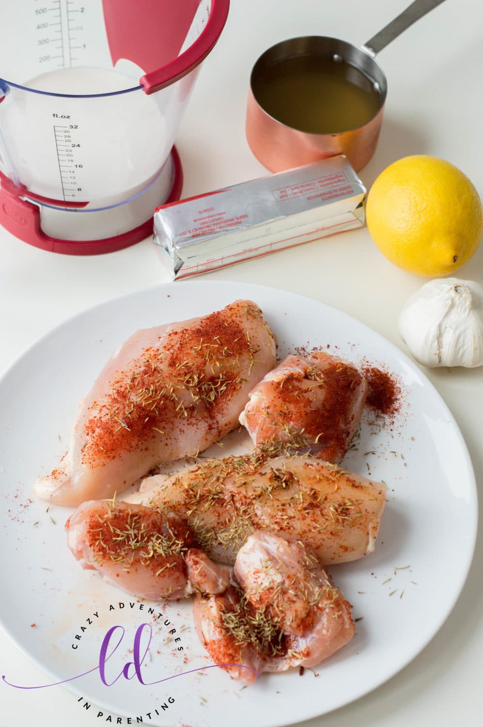 Season the chicken for Instant Pot Lemon Butter Chicken Recipe