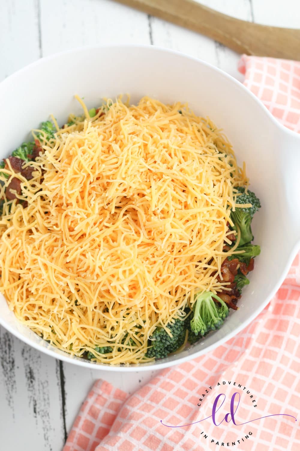 Generously Add Shredded Cheese for Easy Broccoli Salad with Bacon