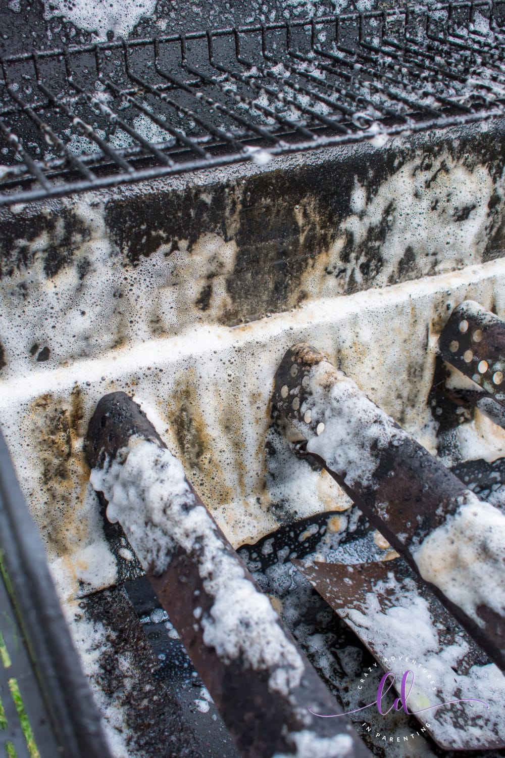 Grease Melting Away with Goo Gone Grill and Grate Cleaner