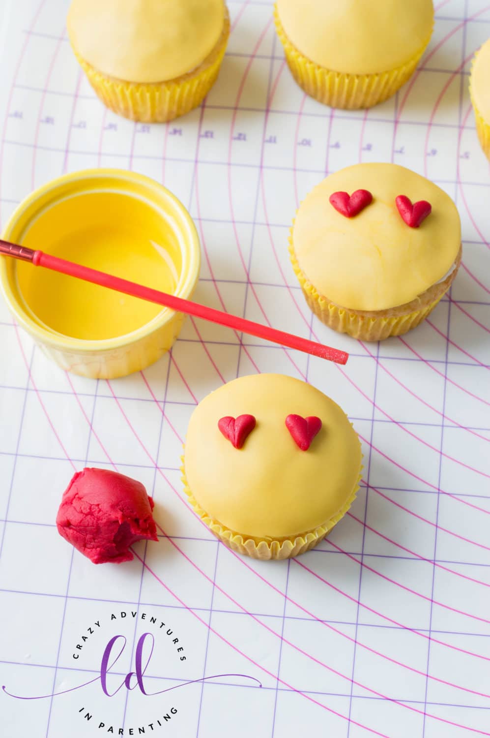 Place Fondant onto Heart Eyes Emoji Cupcakes