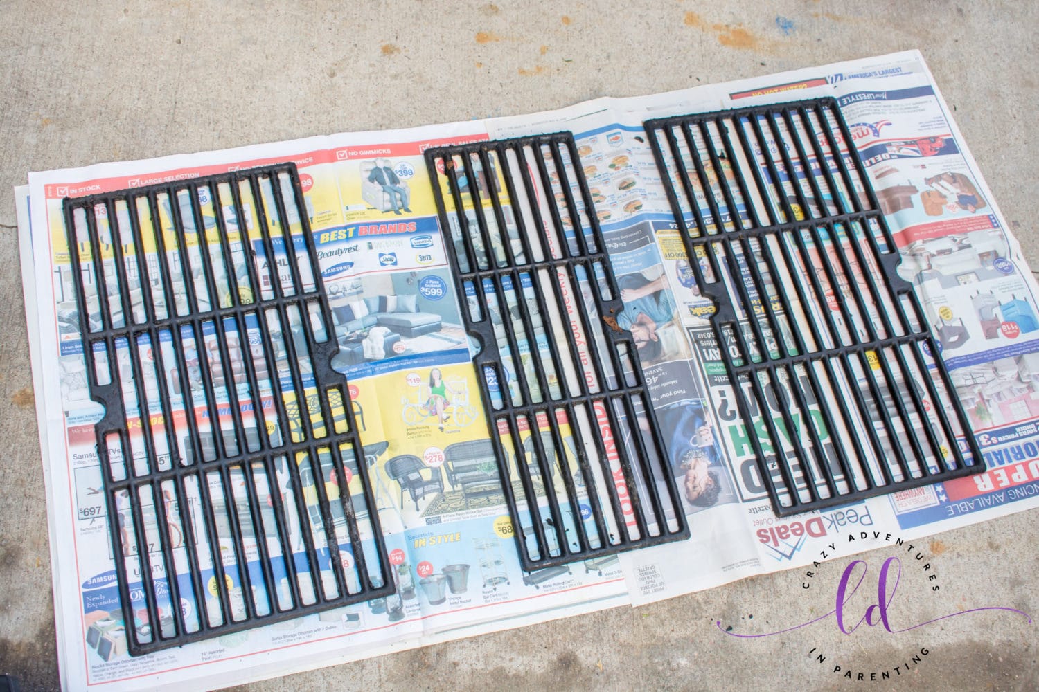 Prepping Grates on Newspaper for Goo Gone Grill and Grate Cleaner
