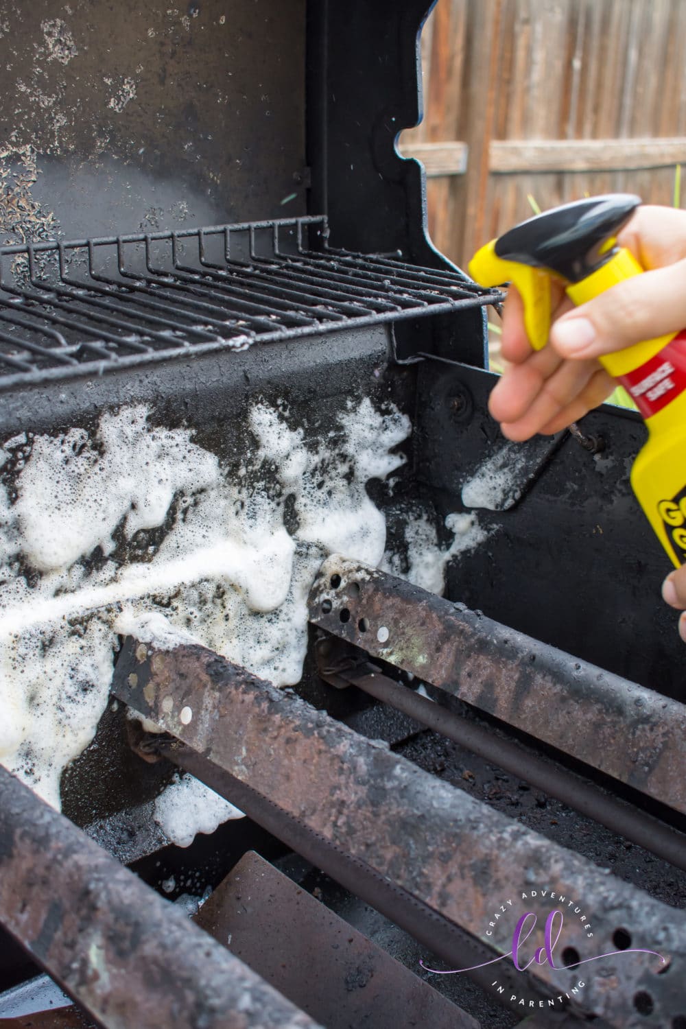 Spraying Goo Gone Grill and Grate Cleaner