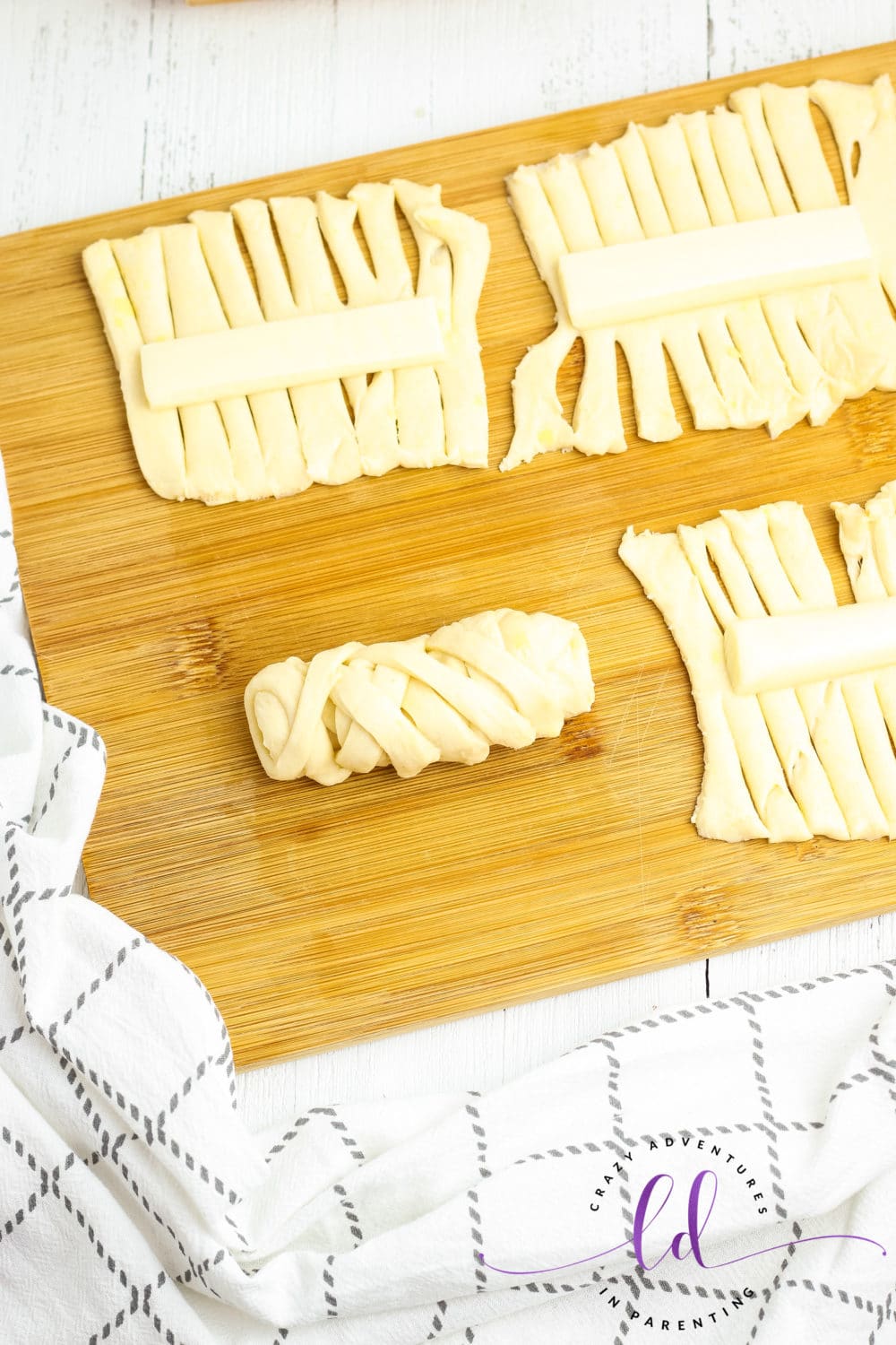 Wrap Dough Around Cheese for Cheesy Mummy Breadsticks