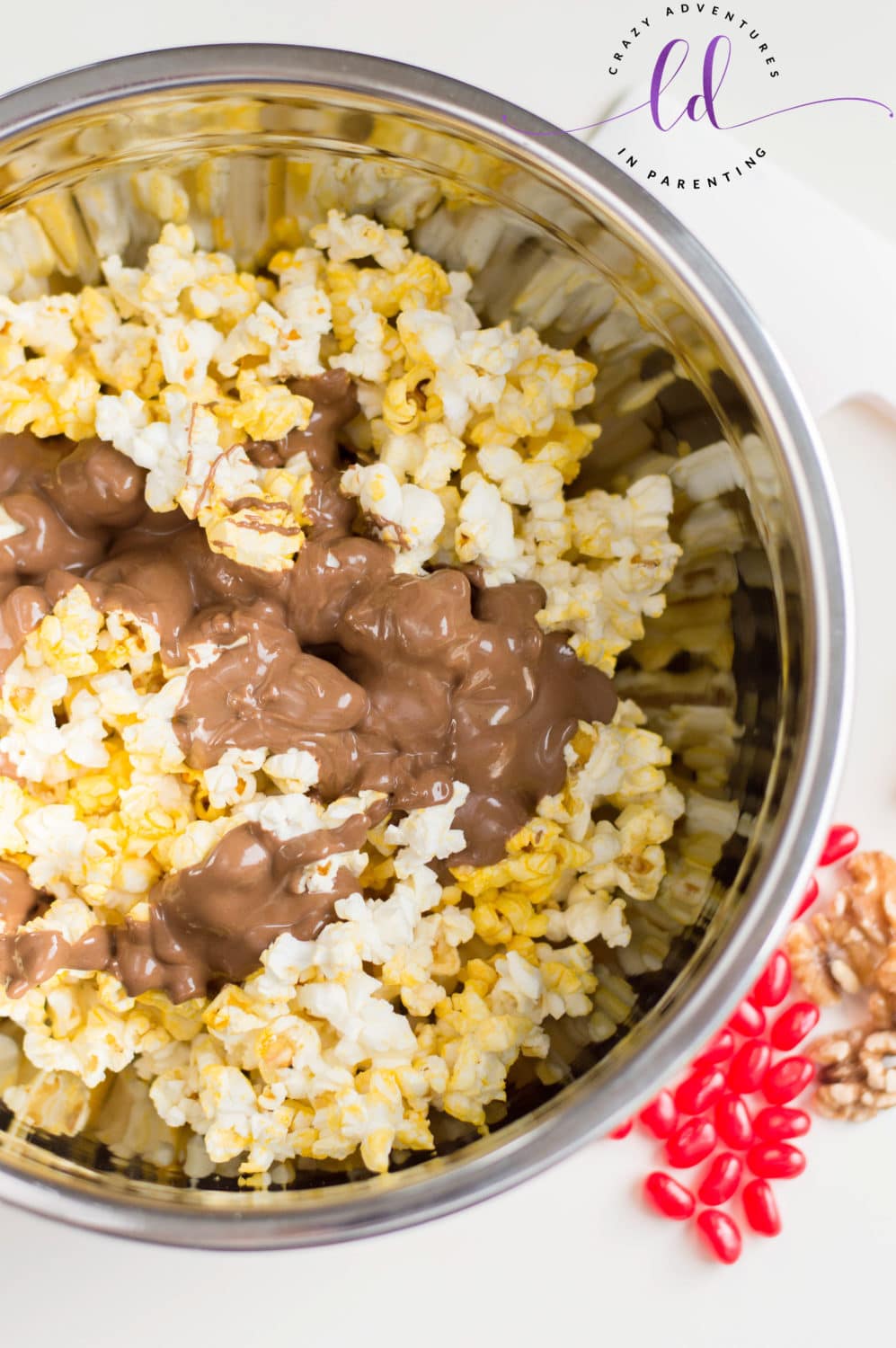 Pour chocolate peanut butter over popped popcorn for Christmas Popcorn Recipe