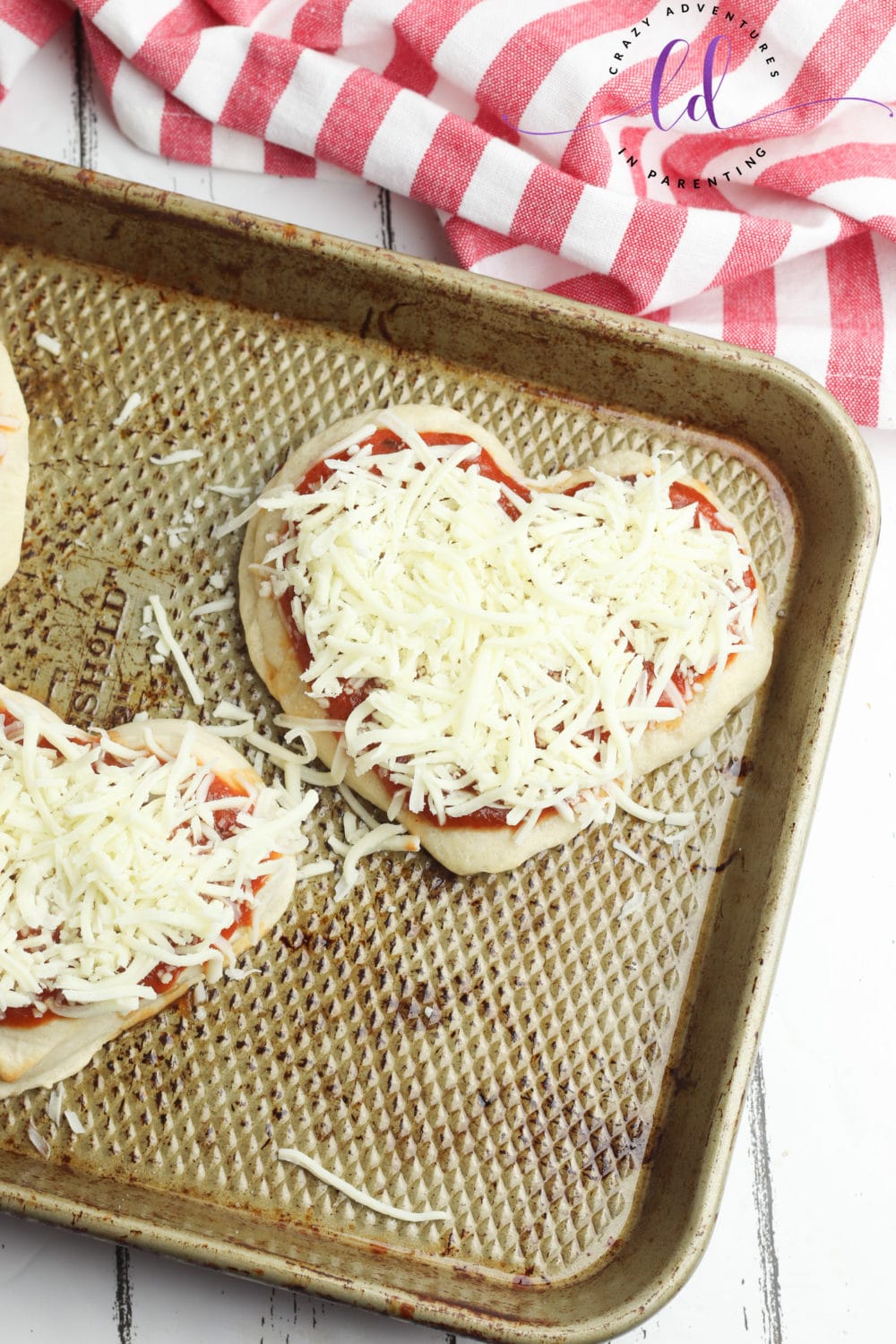 Add Shredded Mozzarella Cheese to Heart-Shaped Pizza for Valentine's Day