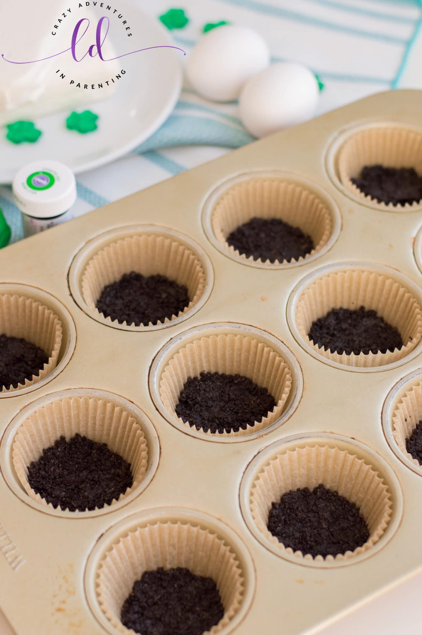 Oreo Cookie Base in Muffin Pans to Make St. Patrick's Day Mini Cheesecakes
