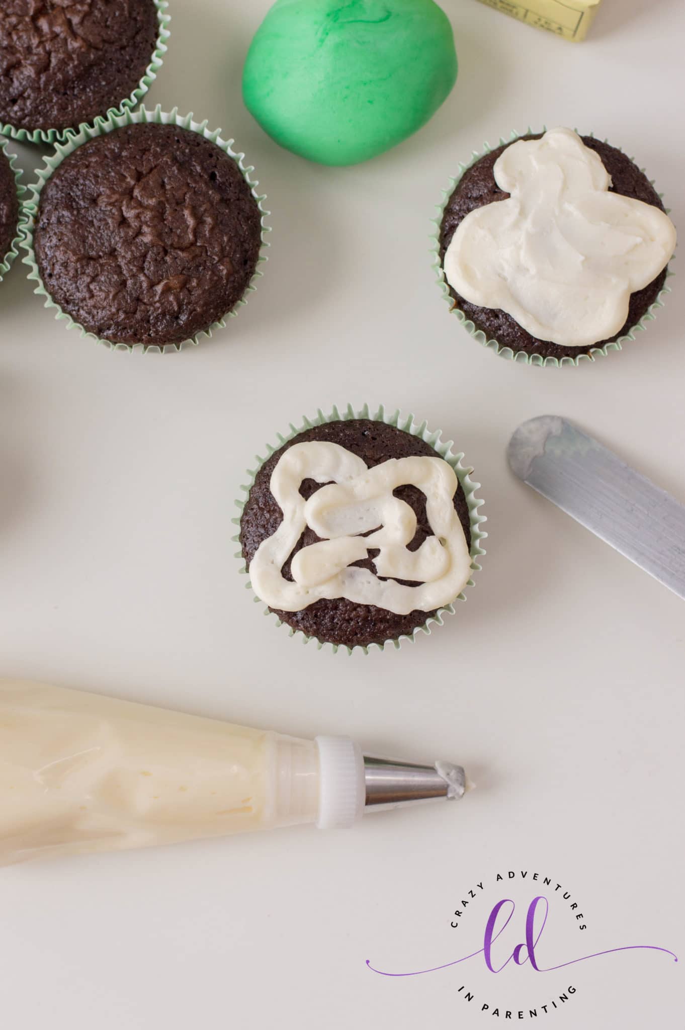 Pipe Frosting onto Green Eggs and Ham Cupcakes