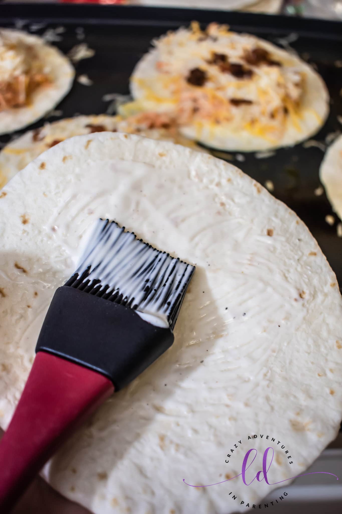 Baste Ranch onto Top Tortilla to Make Buffalo Chicken Bacon Ranch Quesadillas