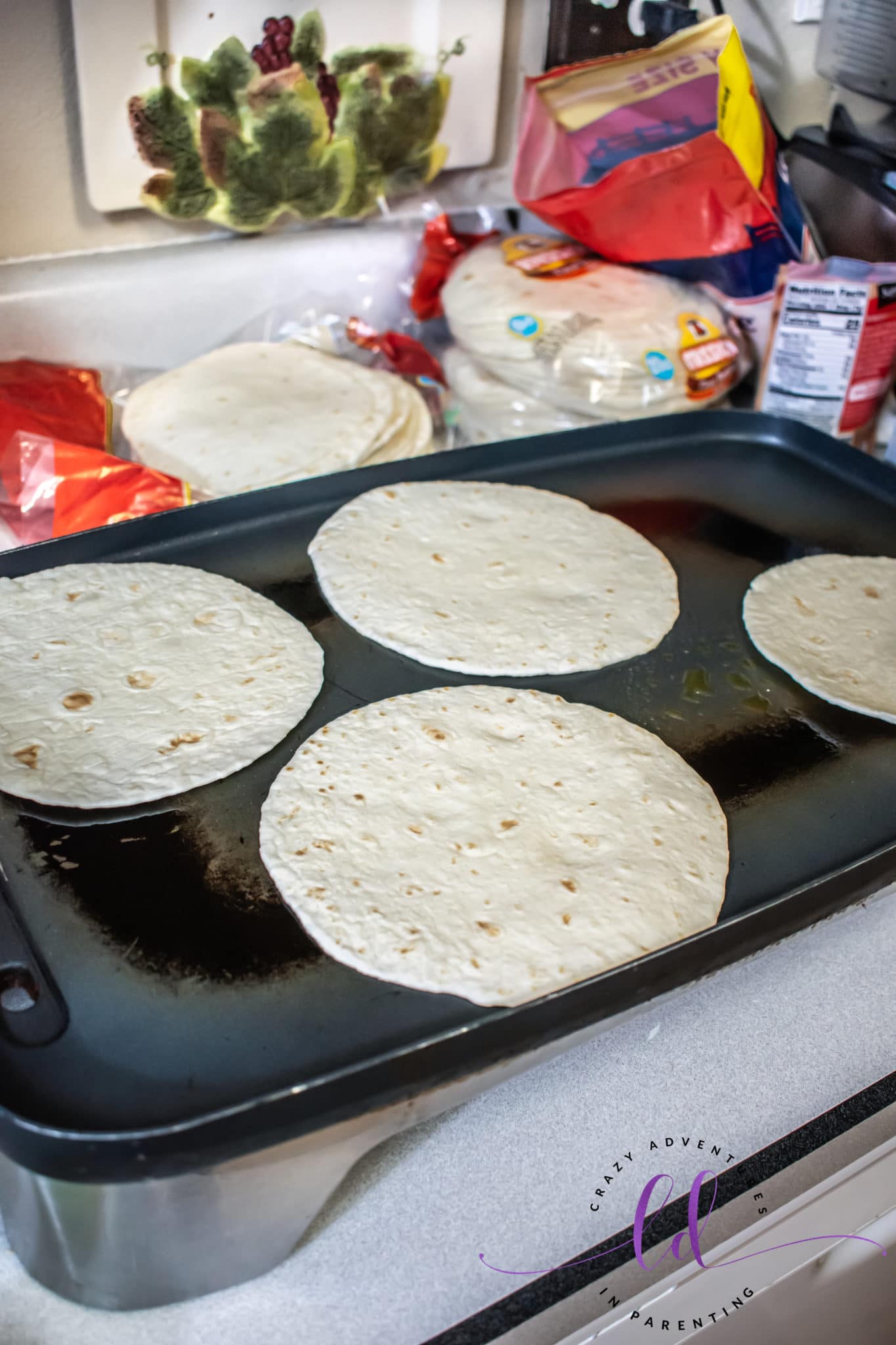 Lay Tortillas on Skillet to Make Buffalo Chicken Bacon Ranch Quesadillas