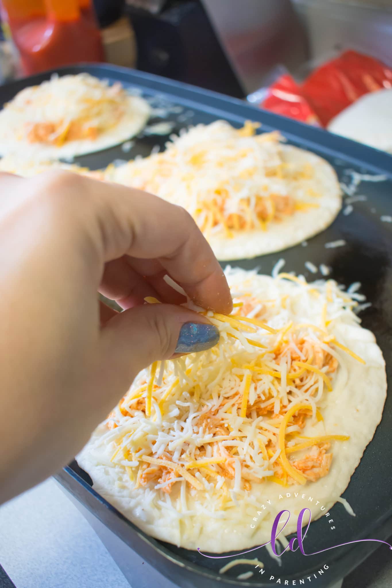 Sprinkle Cheese onto Buffalo Chicken Bacon Ranch Quesadillas